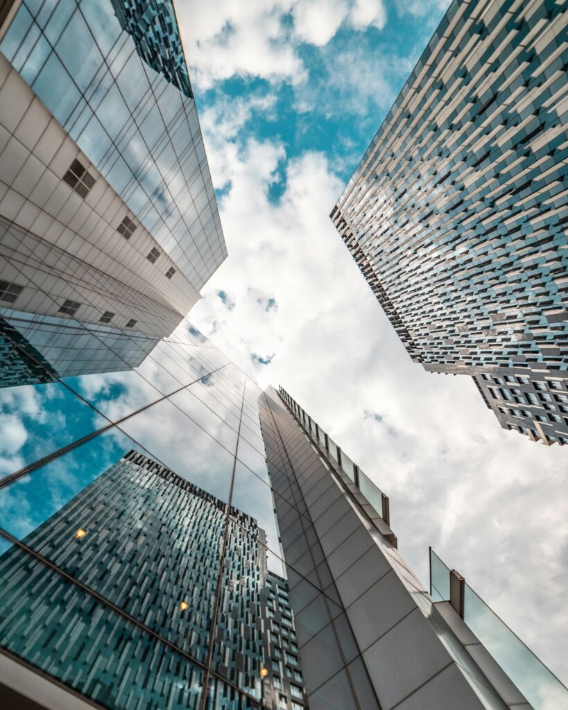 Low angle view of modern skyscrapers reflecting the cloudy sky in Brussels, Belgium.